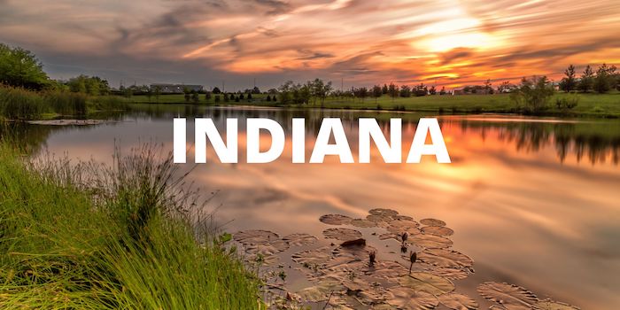 An image of a lake and dunes with INDIANA in the foreground