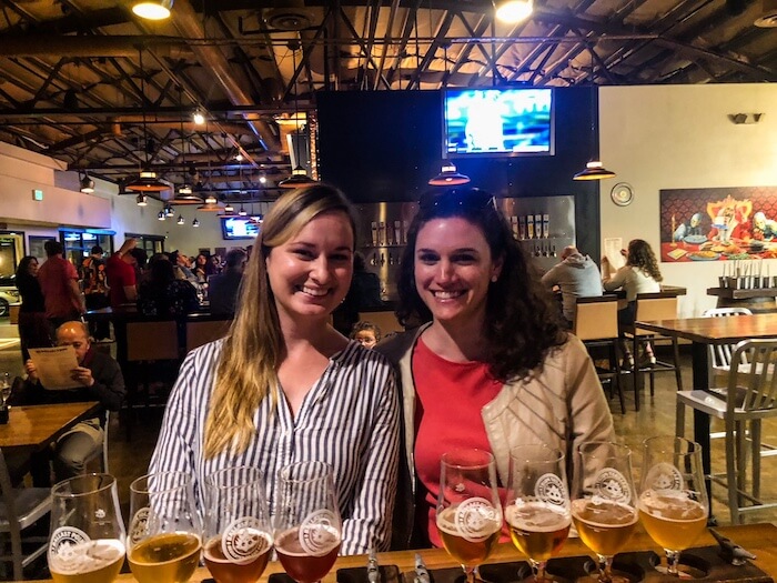 Two ladies prepare to drink beer at Ballast Point, a brewery in San Diego.