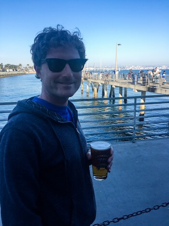 A woman sits and sips a beer at Fathom in San Diego. 