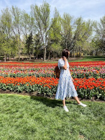A woman stands in a flower field at Thanksgiving Point.