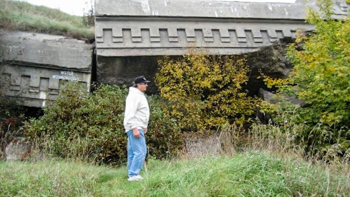 A man walks through a bunker site in Poland.