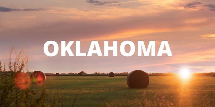 A sunset against a farm landscape with text: OKLAHOMA