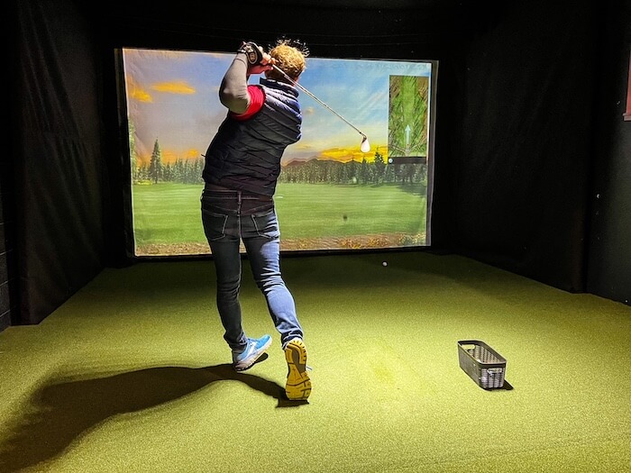 A man takes a swing at Bad Caddy Golf in Salt Lake City.