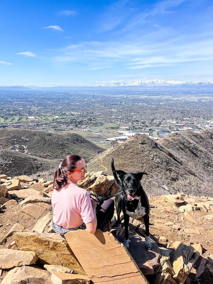 A woman and her dog at the Living Room Lookout in Salt Lake City