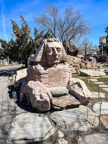 A sphinx in the shape of Joseph Smith at a garden in Salt Lake City