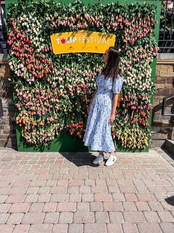 A woman poses at the entrance to the Tulip Festival, one of the top things to do in Salt Lake City.