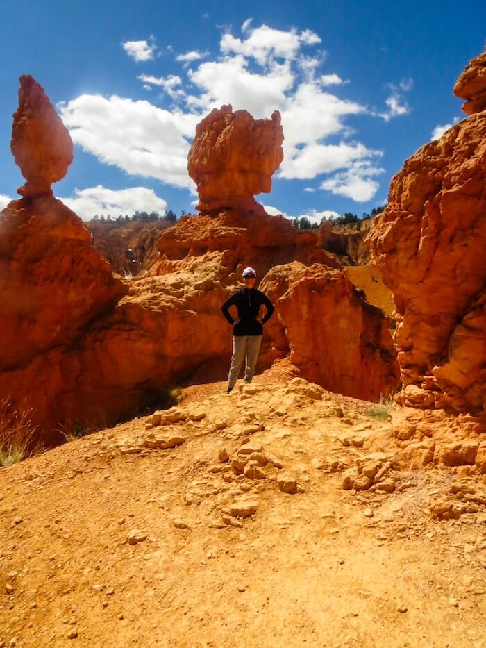A woman poses on a hike in Bryce Canyon National Park.