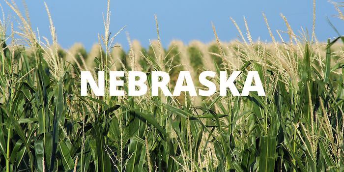 Nebraska cornfields with the word NEBRASKA across the top