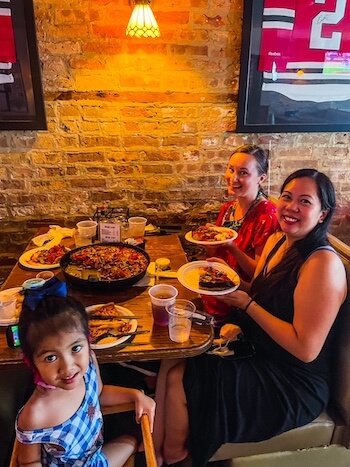 A family gets ready to eat Pequod's Pizza to answer, "Why is Pequod's Pizza so good?"