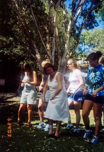 A woman dances in a group.