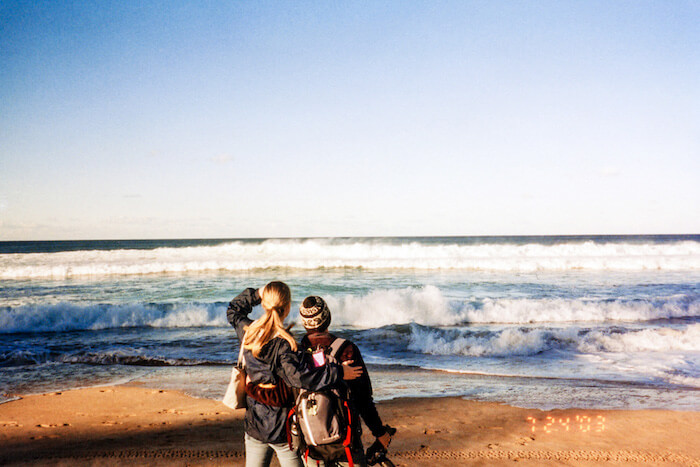 Two friends think about life as they look out at the ocean.