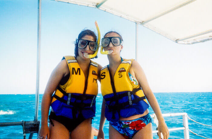 Two travelers prepare to snorkel.