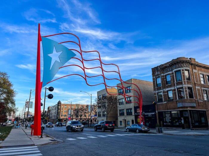 A large flag at the entrance of the main commercial strip in Humboldt Park, Chicago