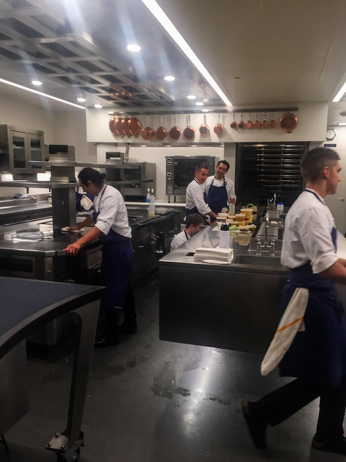 Staff rushes through a kitchen at The French Laundry.