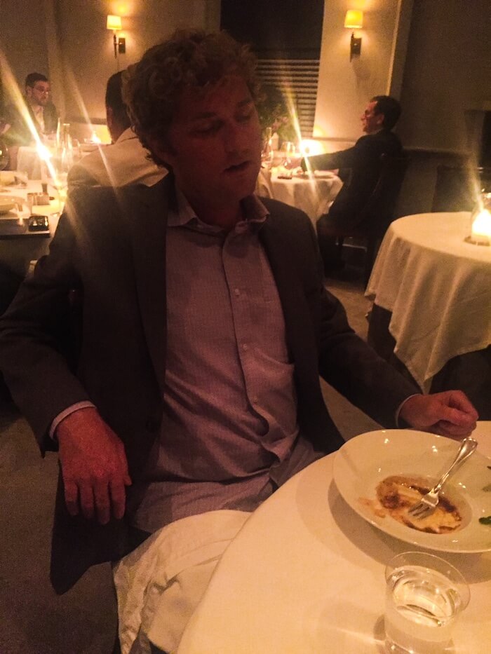 A man tries to rest in between bites of food at The French Laundry.