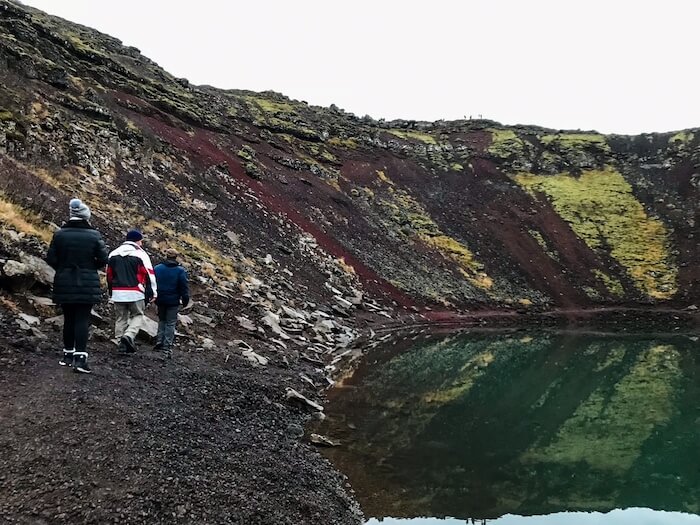 Friends walk inside a crater in Iceland.