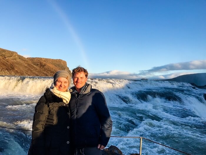 A couple poses at Gullfoss in Iceland.