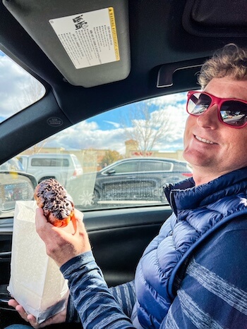 A man eats a donut in Reno.