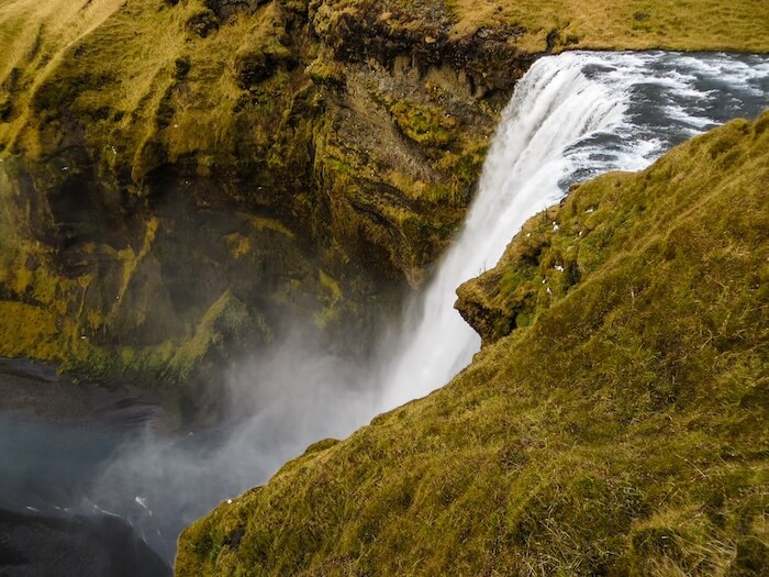 A gushing waterfall down a canyon in Iceland