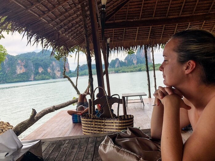 A woman looking at the view on a beach in Thailand