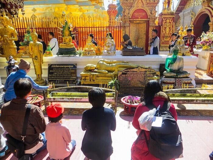 Children praying at a temple in Thailand