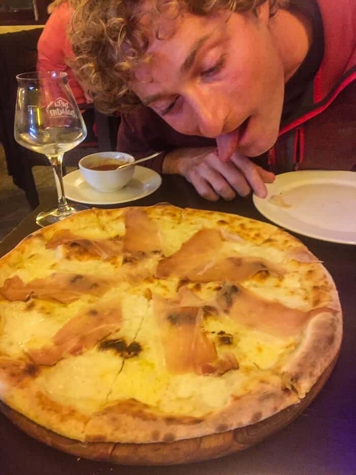 A man gets ready to eat some pizza in Chiang Mai.