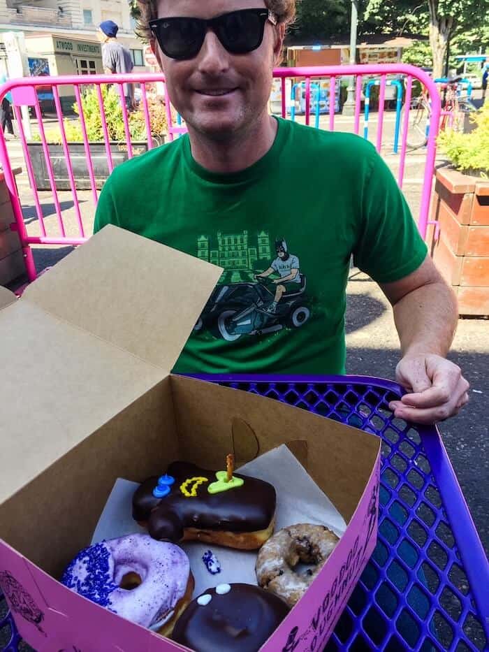 A man gets ready to eat donuts in Portland.