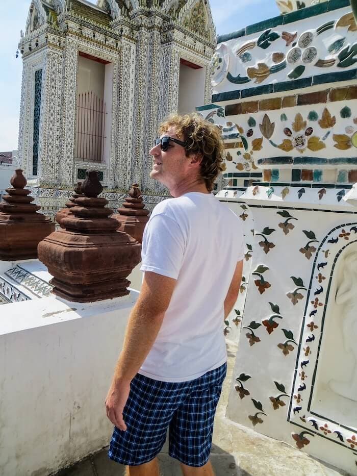 A man explores Wat Arun on a Thailand itinerary.