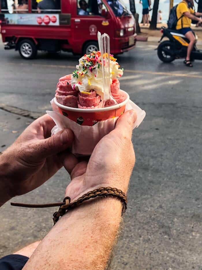 A man holds rolled ice cream in Thailand.