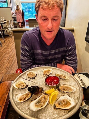 A man gets ready to eat some oysters.