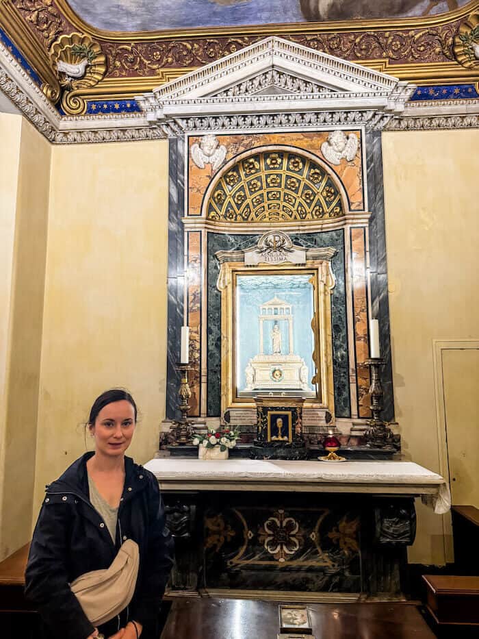 A woman poses with a skull in Sant'Agnese in Agone in Rome.