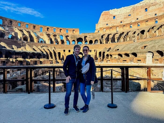 A couple poses at the Colosseum in Rome.