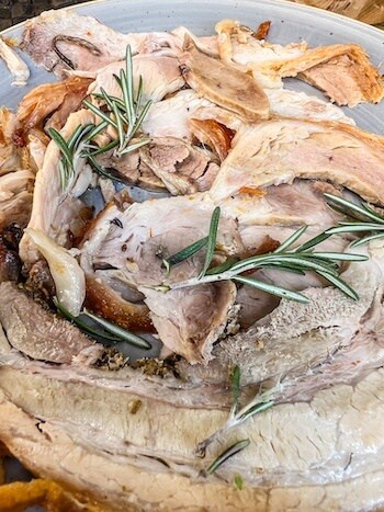 Lunch in Rome consisting of sliced pork topped with thyme