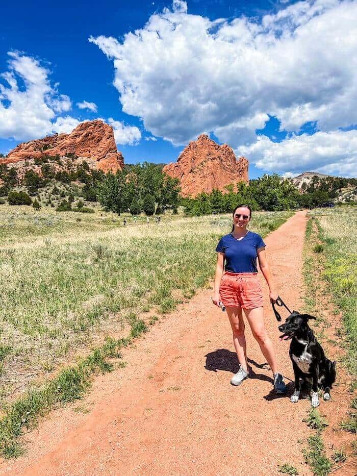 A woman poses with her dog on Garden of the Gods hikes