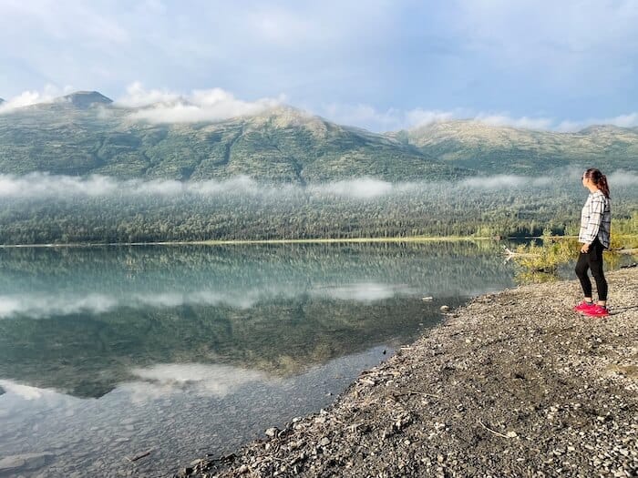 A woman finds time to recharge on a beach in Alaska.