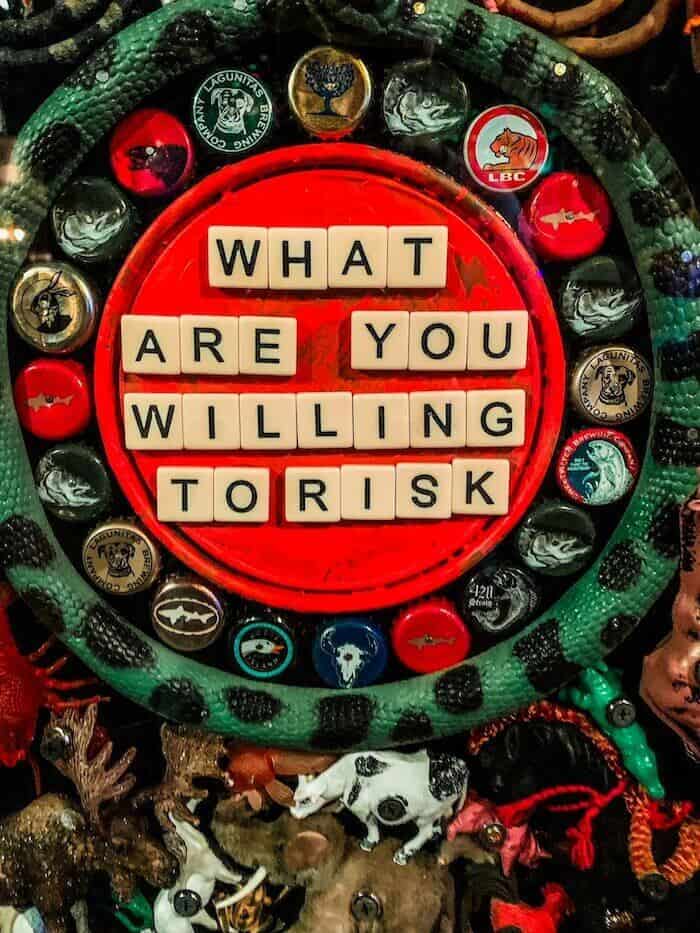A sign that reads, "What are you willing to risk?"