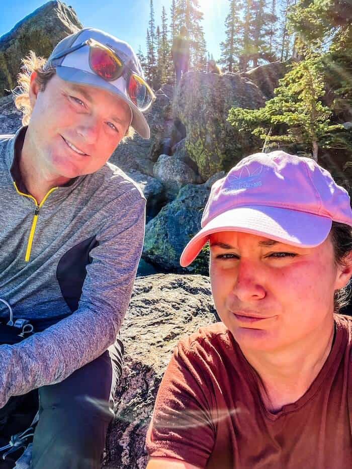 A woman smirks with her husband.