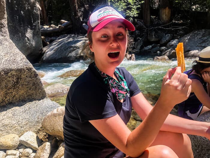 A woman holds a chip in a funny way.