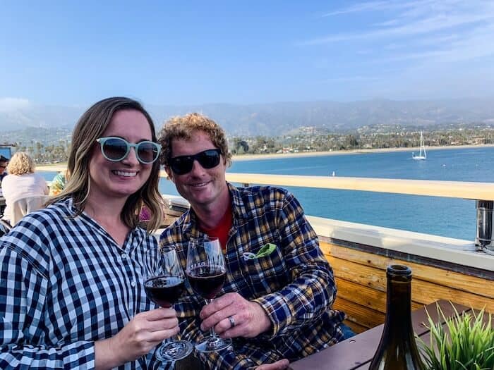 A couple drinks wine on the pier in Santa Barbara.