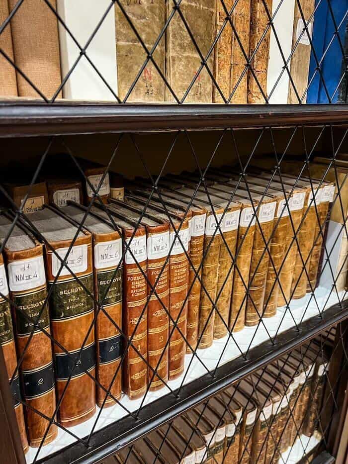 Old library books in a historic library in Bologna to answer, "Is Bologna worth visiting?"