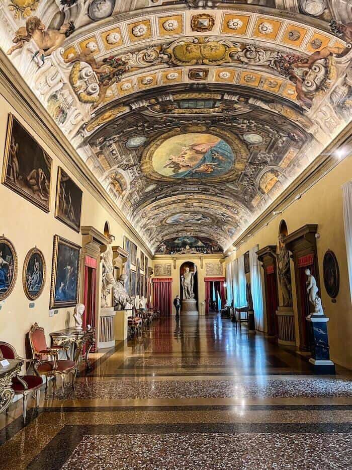 A beautiful hallway in a museum as a response to, "Is Bologna worth visiting?"