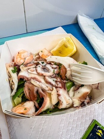 Fresh octopus at a fish market in Bologna, Italy, with a fork ready to nab some