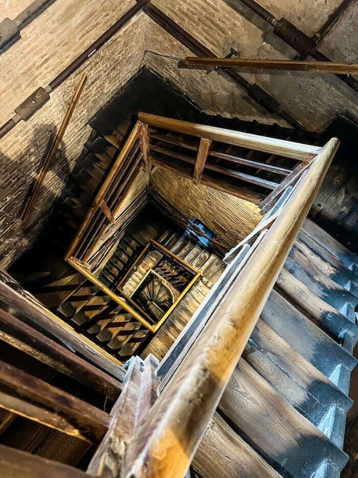 Inside a spiral staircase in Bologna to answer, "Is Bologna worth visiting?"