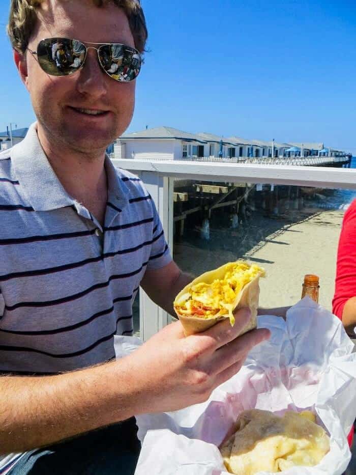A man gets ready to eat a burrito at Kono's Cafe in San Diego, California.
