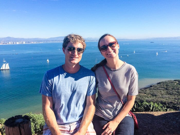 A couple poses with a smile at the top of  Cabrillo National Monument.