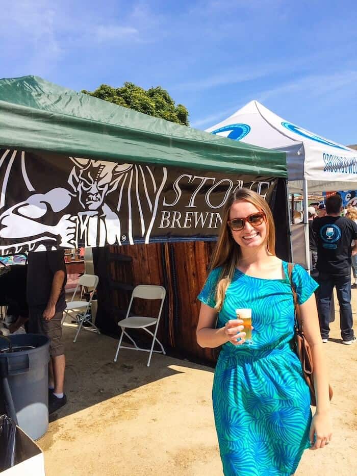 A woman poses with a beer at a festival in San Diego, California.