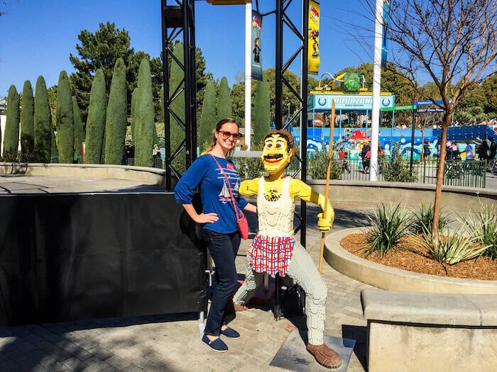 A woman poses with a chef made out of blocks in LEGOLAND.