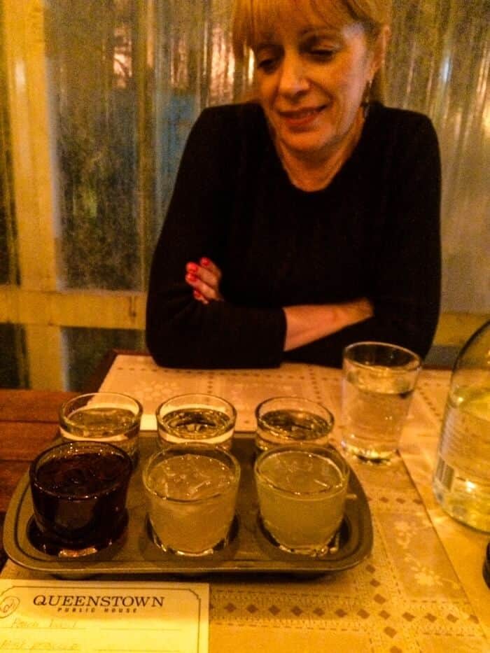 A woman looks at a flight of sangrias at a restaurant in San Diego, California.