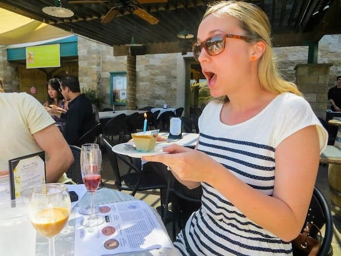 A woman celebrates her birthday with treats and sparkling wine in Temecula, California.