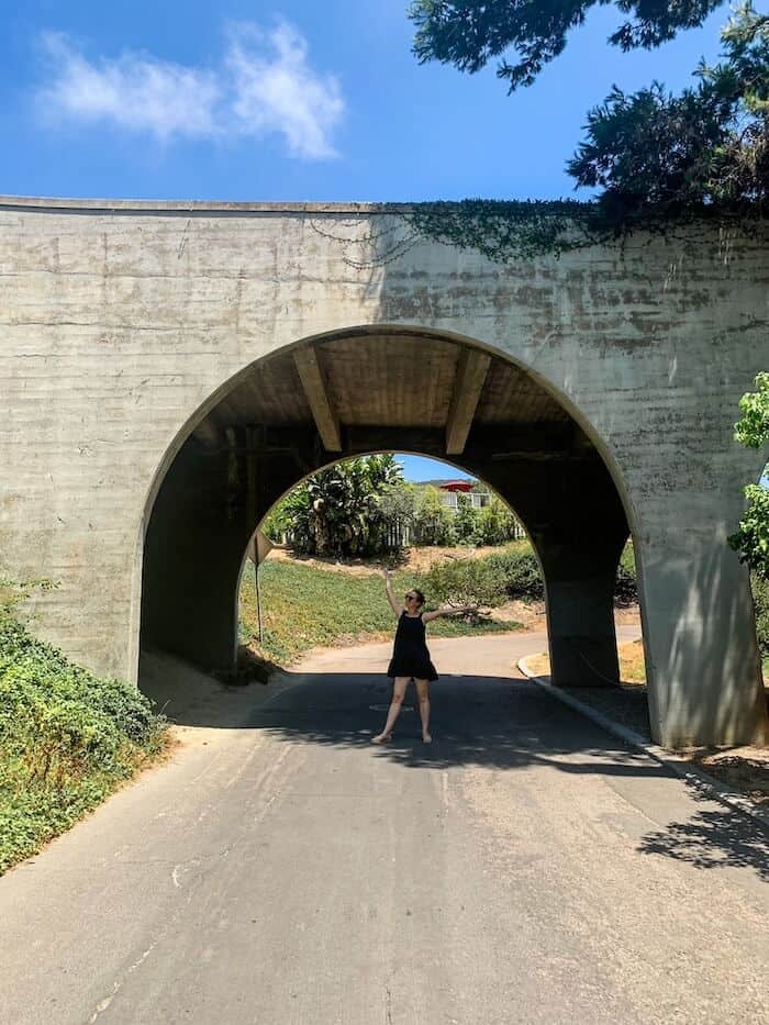 A woman poses underneath a "troll bridge" in La Jolla, San Diego.